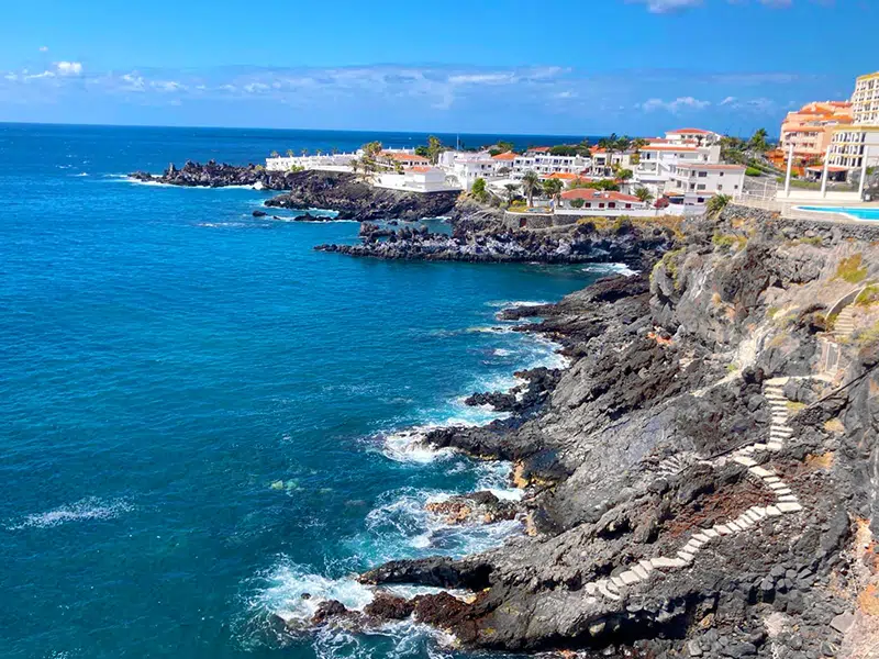 Tropical island of Tenerife spain Panorama of the Coastline with buildings with pool on the island of Tenerife blue sky color and blue water color