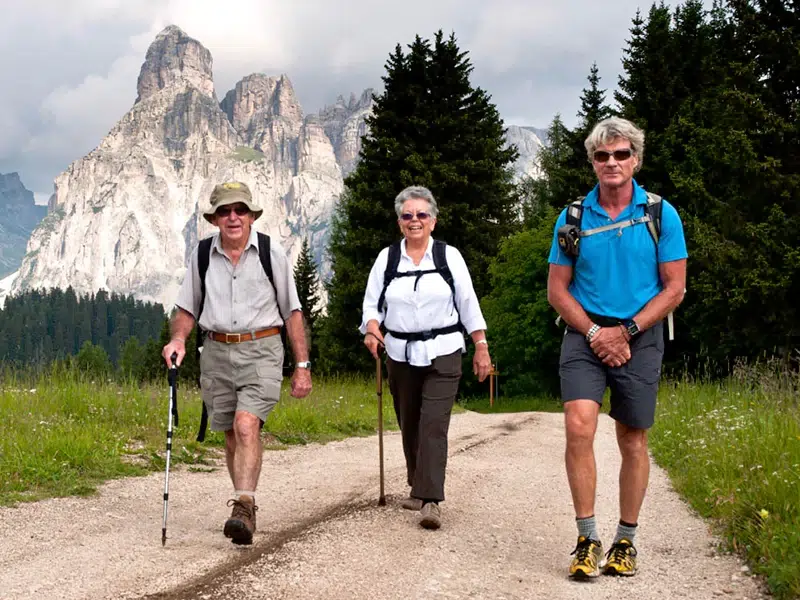 hiking happy old man with tour guide