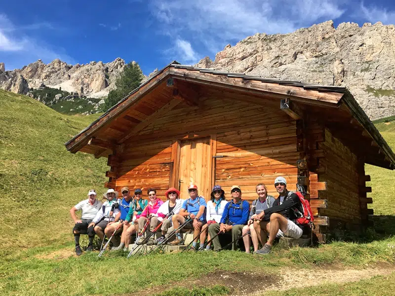 walking tour dolomites trekkers sit beside beautiful hut